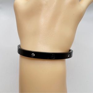 Black metal with simulated diamonds, love bracelet.